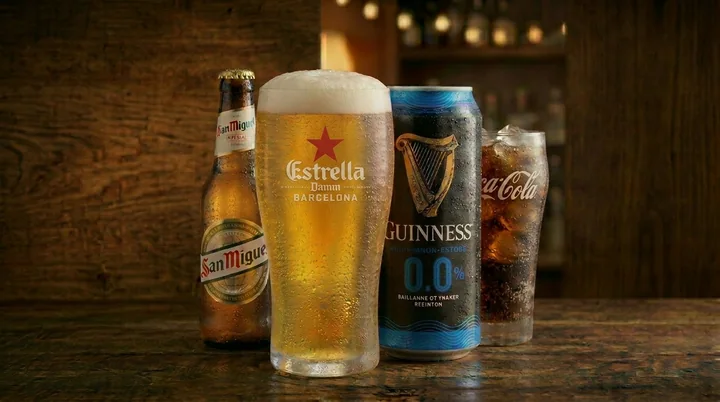 Beer, alcohol-free beer and cola on a wooden bar counter